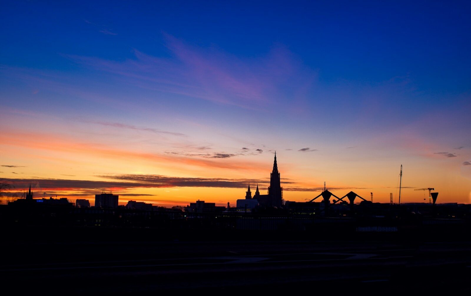 silhouette of city buildings during sunset